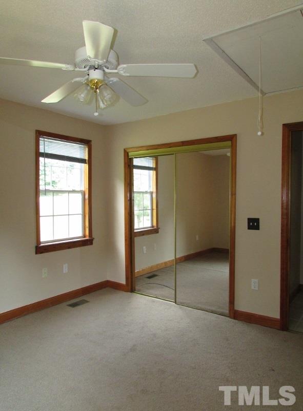558 Robert Gentry Road Timberlake, NC 27583 - Photo 14 of 25 Bedroom 3 also has new carpet, mirrored closet doors, ceiling fan too.