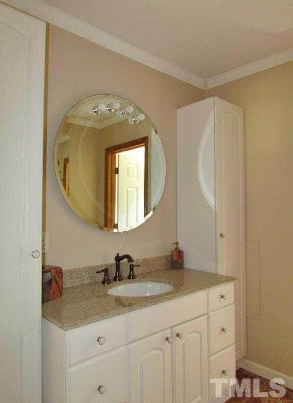 558 Robert Gentry Road Timberlake, NC 27583 - Photo 16 of 25 This bathroom has the toilet and shower in one room and vanity in the other to offer privacy. New tile floor, granite sink top, faucets too.