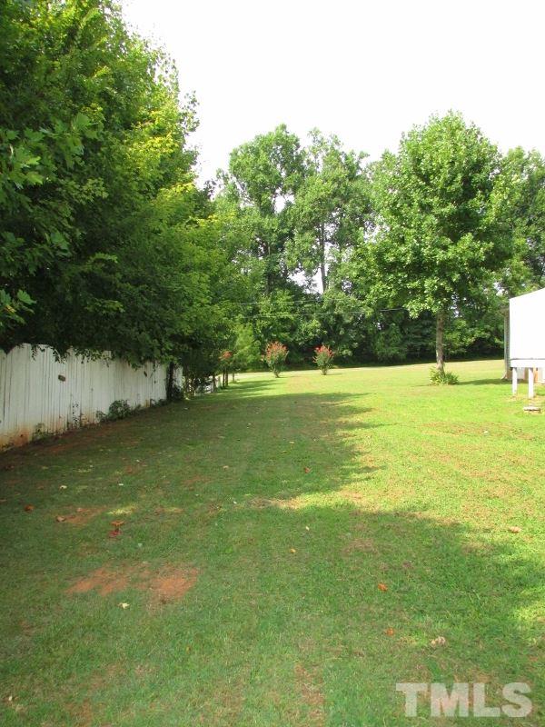 558 Robert Gentry Road Timberlake, NC 27583 - Photo 20 of 25 Back yard is shaded from neighbors trees and has a privacy fence already in place.
