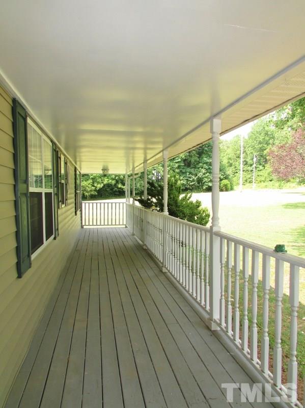 558 Robert Gentry Road Timberlake, NC 27583 - Photo 3 of 25 Plenty of room for rocking chairs and swings on this covered porch.