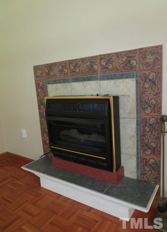 558 Robert Gentry Road Timberlake, NC 27583 - Photo 5 of 25 Gas log fireplace with decorative tile trim will be appreciated on a cool or damp evening.