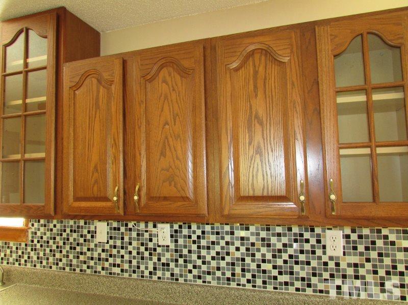 558 Robert Gentry Road Timberlake, NC 27583 - Photo 7 of 25 Oak cabinets with cathedral design doors, inlaid tile back splash, freshly painted interior too.