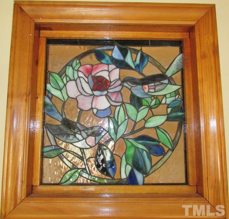 558 Robert Gentry Road Timberlake, NC 27583 - Photo 9 of 25 Another accent feature to this home is the seller installed a neat stained glass picture of birds that you can see from the dining and hall.
