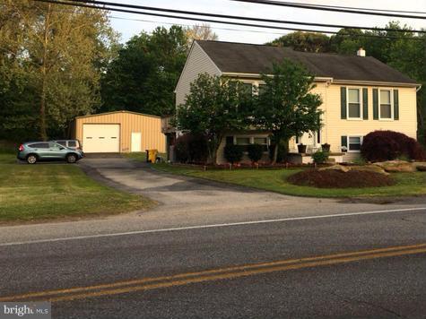 8107 Hog Neck Road Pasadena, MD 21122 - Photo 2 of 27 a view of a house with a yard and a street