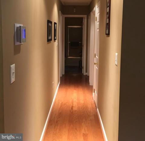 8107 Hog Neck Road Pasadena, MD 21122 - Photo 11 of 27 a view of a hallway with wooden floor