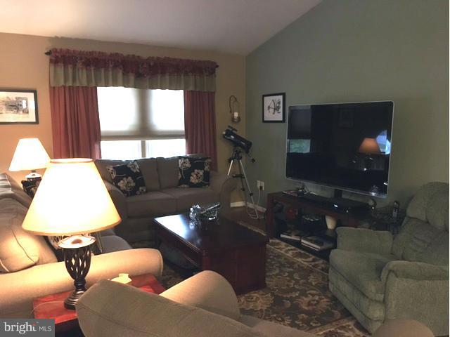 8107 Hog Neck Road Pasadena, MD 21122 - Photo 12 of 27 a living room with furniture and a flat screen tv