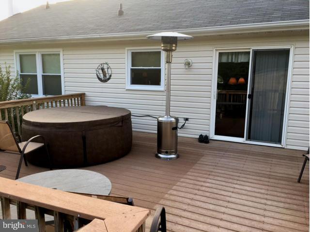 8107 Hog Neck Road Pasadena, MD 21122 - Photo 13 of 27 a view of a house with a barbeque and wooden fence