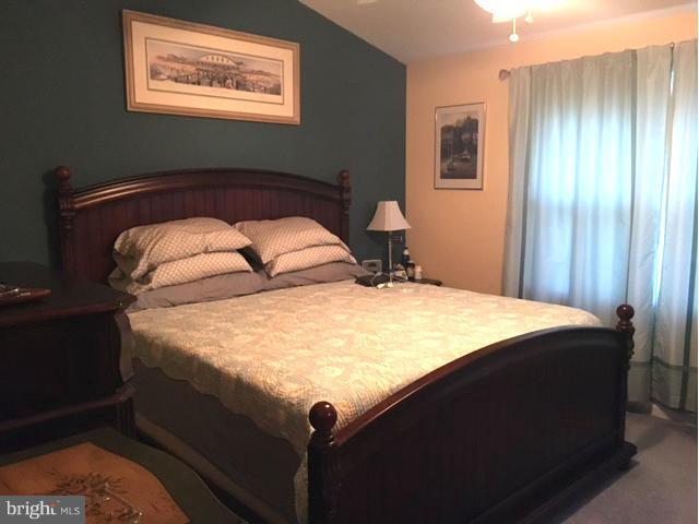 8107 Hog Neck Road Pasadena, MD 21122 - Photo 16 of 27 a bed sitting in a bedroom next to a window