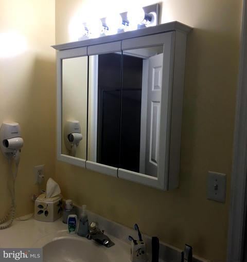 8107 Hog Neck Road Pasadena, MD 21122 - Photo 18 of 27 a bathroom with a sink and a mirror