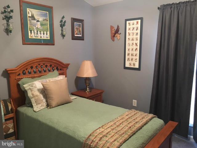 8107 Hog Neck Road Pasadena, MD 21122 - Photo 20 of 27 a bed sitting in a bedroom next to a window