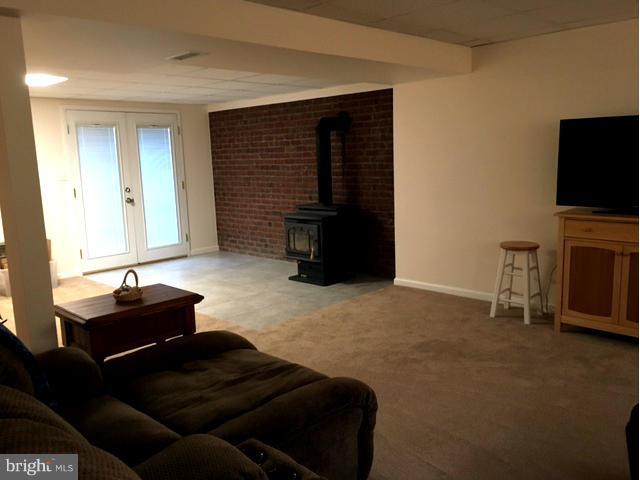 8107 Hog Neck Road Pasadena, MD 21122 - Photo 25 of 27 a living room with furniture and a flat screen tv