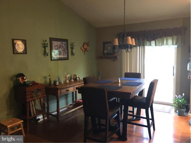 8107 Hog Neck Road Pasadena, MD 21122 - Photo 7 of 27 a view of a dining room with furniture and window
