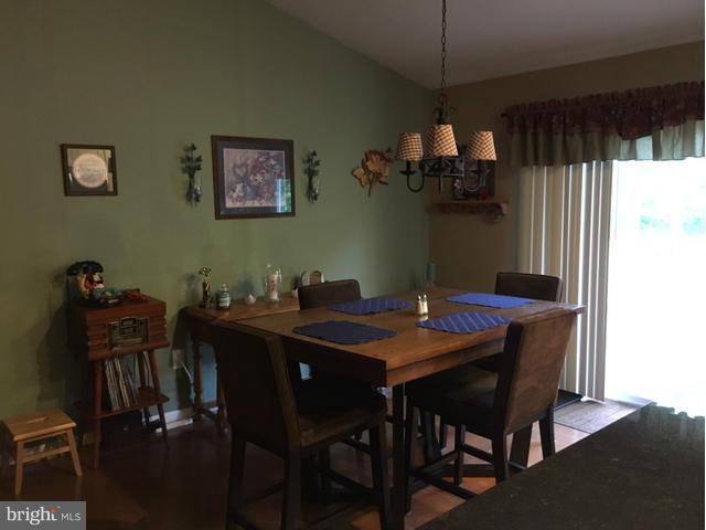8107 Hog Neck Road Pasadena, MD 21122 - Photo 8 of 27 a view of a dining room with furniture and chandelier