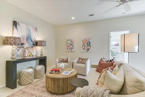 a bedroom with furniture and a wooden floor