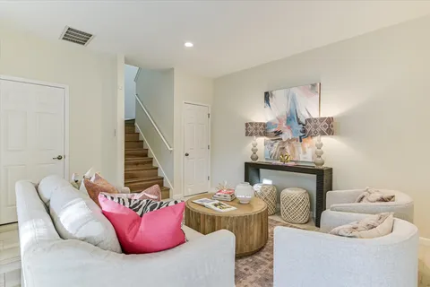 a living room with furniture fireplace and rug
