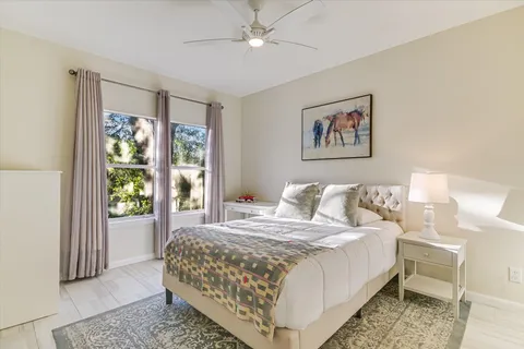 a bedroom with a large bed and a window