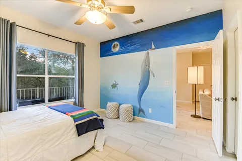 a bedroom with a bed and a large window