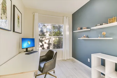 a workspace with furniture and window