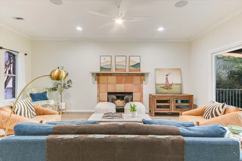a living room with furniture and a chandelier