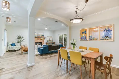 a view of a dining room with furniture wooden floor and a chandelier