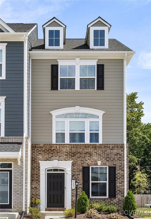 a front view of a house with yard and windows