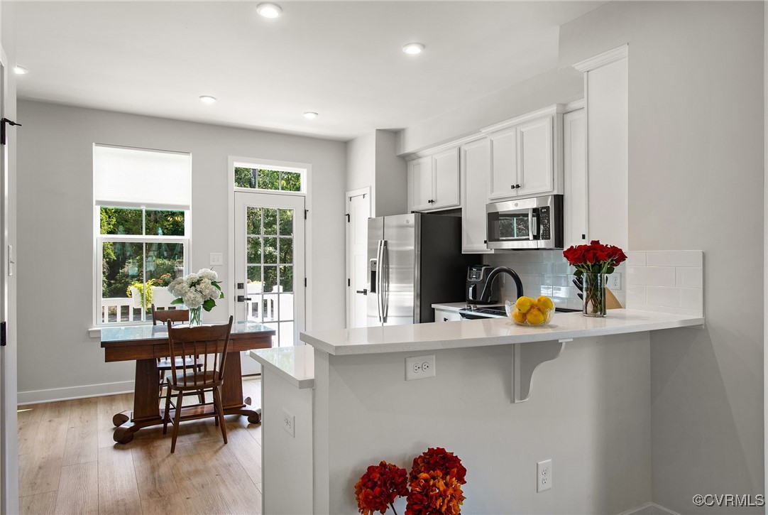 1321 Ewing Pk Loop Midlothian, VA 23113 - Photo 14 of 30 a room with stainless steel appliances a kitchen island furniture a flat screen tv and a kitchen view