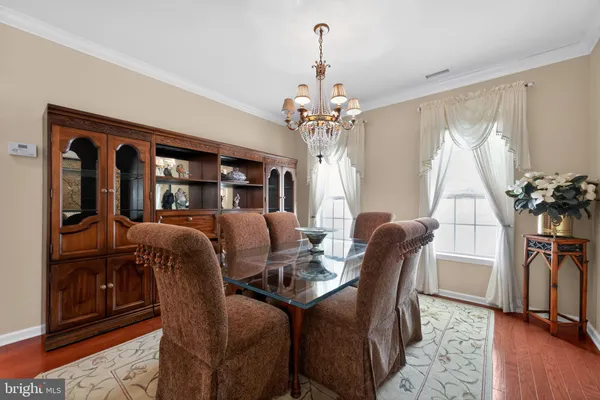 a view of a dining room with furniture and a chandelier