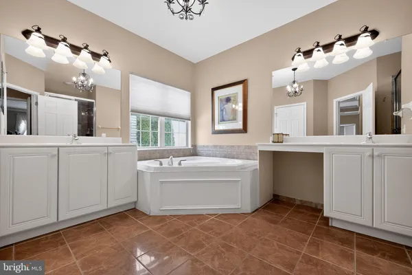 a bathroom with a sink vanity and mirror