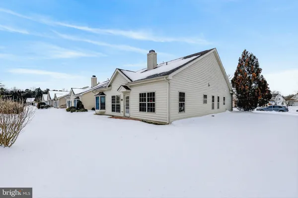 a view of a white house with a yard