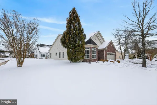 a view of house with a yard covered with snow