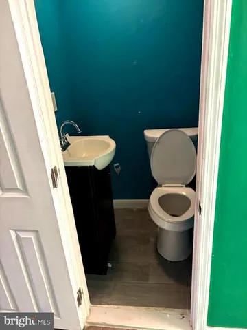 a toilet sitting in a bathroom next to a sink