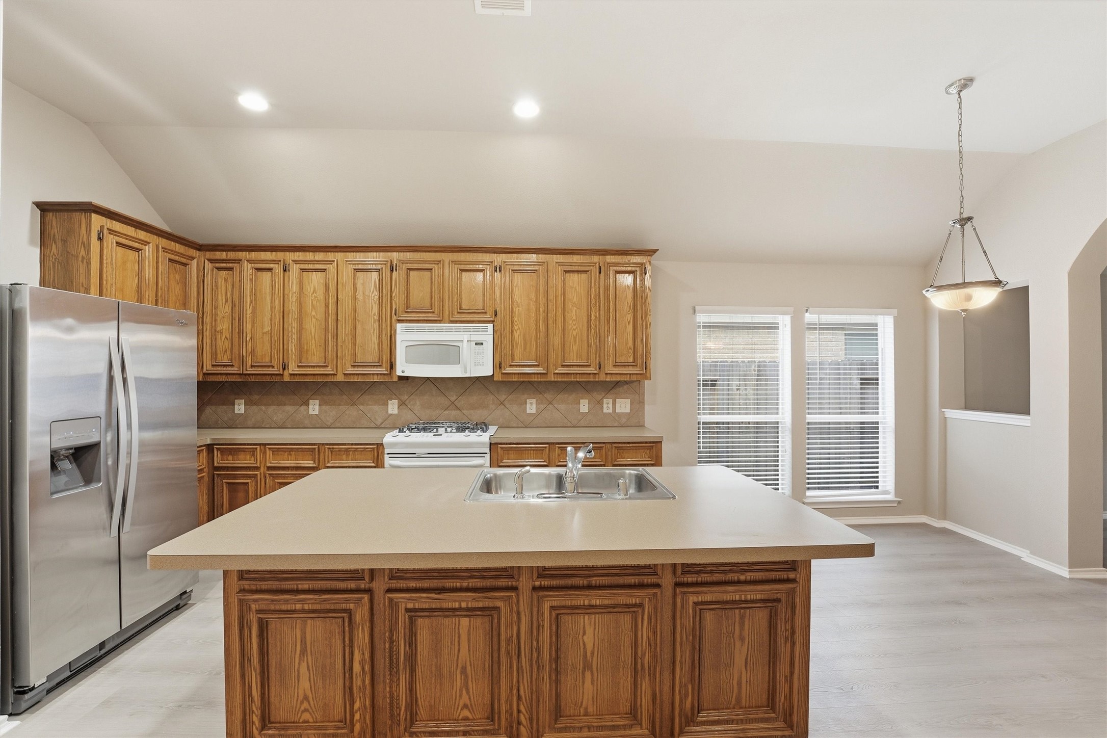 20931 Hamlet Ridge Lane Katy, TX 77449 - Photo 8 of 23 Well-appointed kitchen featuring classic wooden cabinetry and ample storage. Gas range, microwave and fridge included.