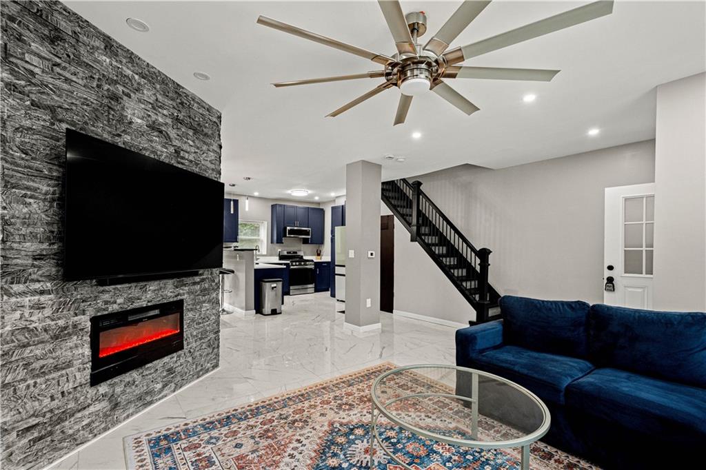 214 North Aiken Avenue Pittsburgh, PA 15206 - Photo 4 of 37 Floor-to-ceiling stone wall, recessed lighting and modern ceiling fan