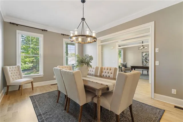 a large kitchen with a table and chairs