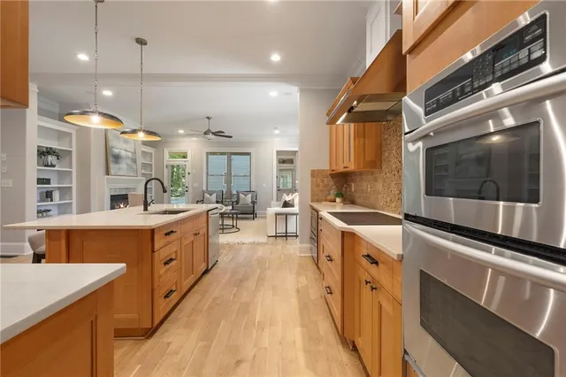 a view of a dining room with furniture a chandelier and wooden floor