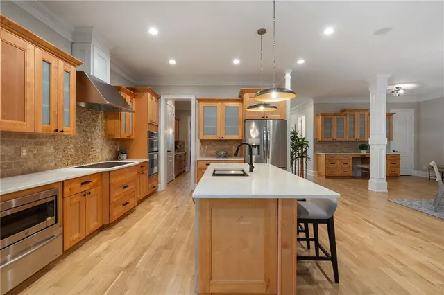 a view of a hallway with wooden floor and stairs