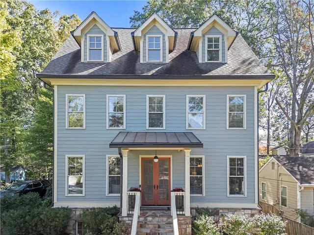 a living room with furniture a chandelier and a window