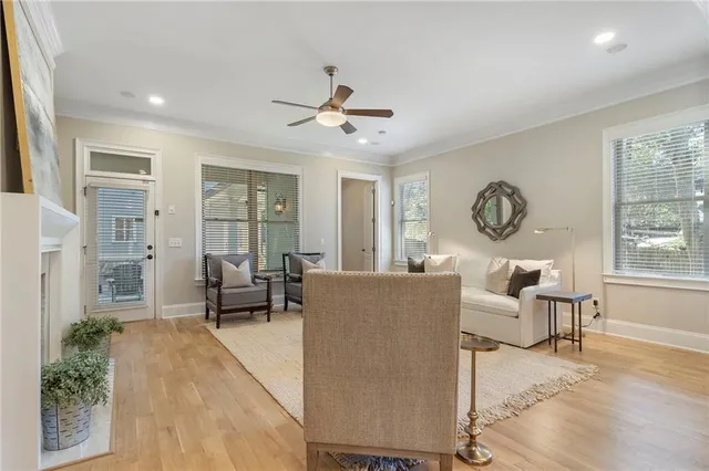 a view of a room with a ceiling fan and window