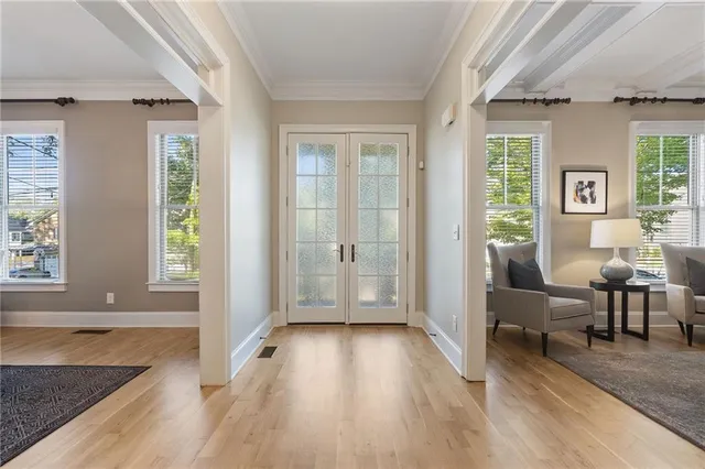 a living room with a table chairs and a chandelier