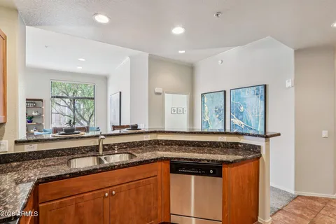a kitchen with granite countertop a sink and a window