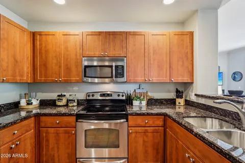 a kitchen with sink a microwave and cabinets