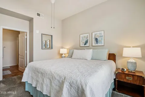 a bedroom with a bed and a night stand