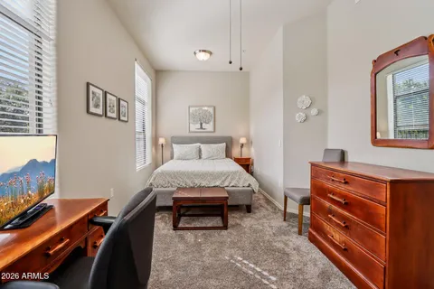 a bedroom with a bed and a desk