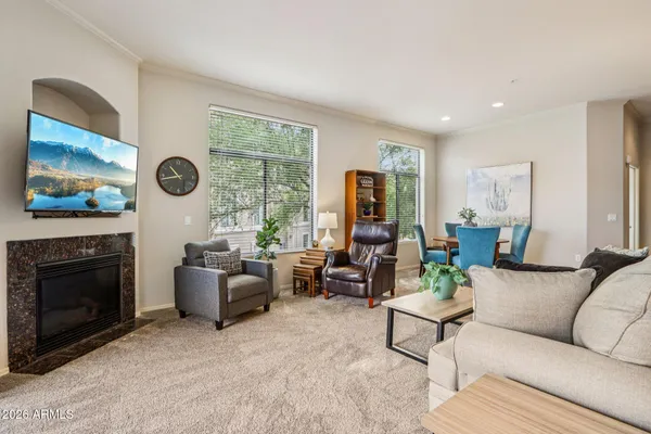 a living room with furniture a fireplace and a flat screen tv