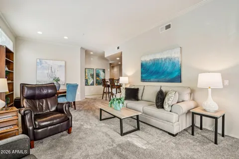 a living room with furniture and a lamp