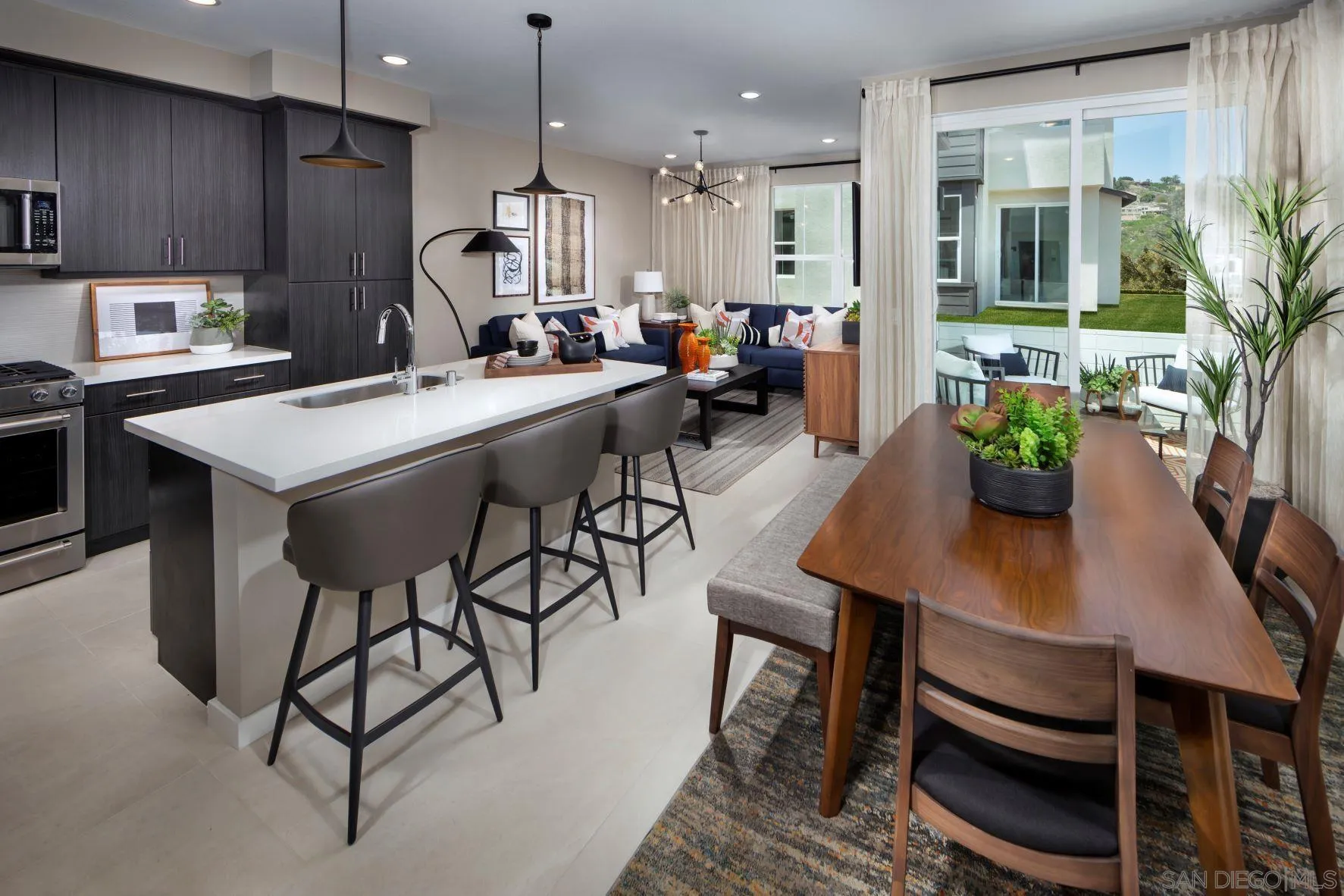 13075 Olympus Circle, Unit 1 Poway, CA 92064 - Photo 1 of 16 a kitchen with stainless steel appliances kitchen island granite countertop a table chairs sink and cabinets