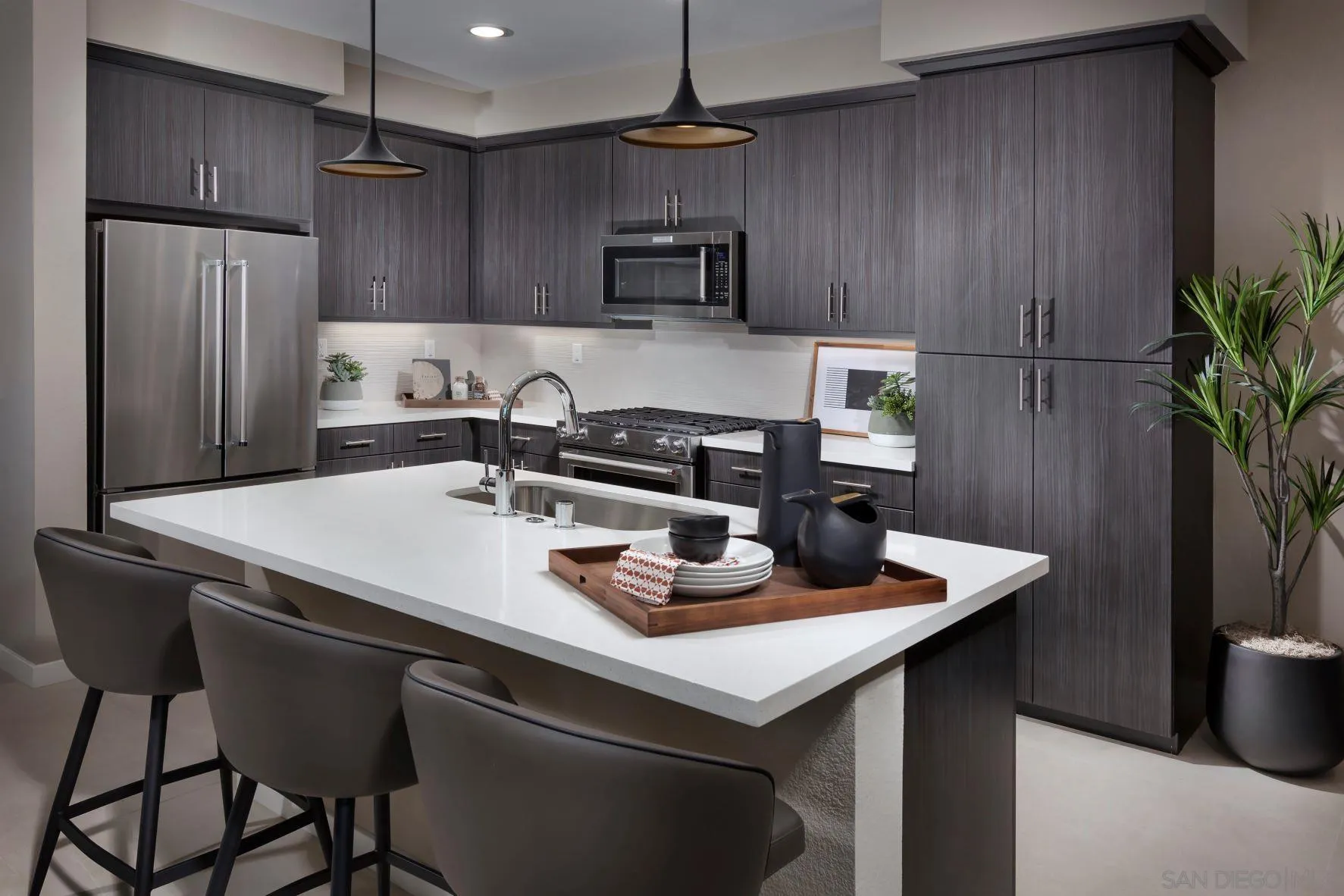 13075 Olympus Circle, Unit 1 Poway, CA 92064 - Photo 7 of 16 a kitchen with granite countertop a table chairs stove and refrigerator