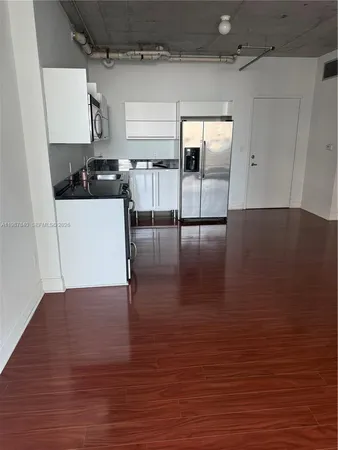 a view of a kitchen with a sink and cabinets
