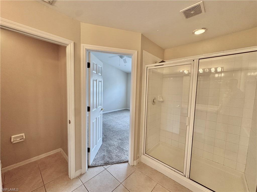912 Hampton Circle, Unit 92 Naples, FL 34105 - Photo 13 of 31 Full bathroom featuring a shower stall, light tile patterned floors, light colored carpet, and recessed lighting