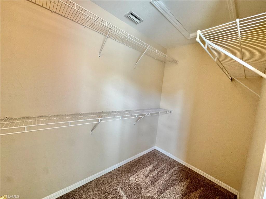 912 Hampton Circle, Unit 92 Naples, FL 34105 - Photo 14 of 31 Spacious closet featuring carpet flooring